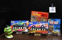 Group of items including the Hot Rod Cartoons comic (July 1968), four Hot Wheels Color FX die-cast cars in original 1993 packaging, one Johnny Lightning Hot Rod die-cast car with trading card, and the Ugly Surfer clip-on toy