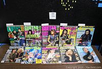 Group shot of 10 vintage Guitar World magazines from 1987-1994 with colorful covers featuring rock guitarists