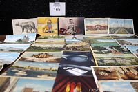 Postcards spread out showing a variety of locations and images, front sides visible.