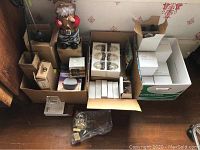 Various boxed new items including wood 3-D puzzles, solar lights, and miscellaneous decorative items including Santa figurine