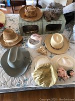 Full view of vintage hats, wigs on two hat boxes on surface