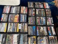 Overhead view of multiple black soft DVD carrying cases filled with DVDs
