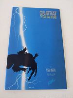 Front cover of comic book showing title, silhouette art of dark knight gnat with lightning, blue background.