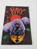 Front cover photo of The Maxx Issue 1 comic book featuring The Maxx character with a red sun background