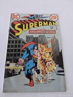 Front cover of Superman comic book issue 263 showing Superman partially engulfed in molten steel in an urban background.