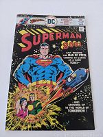 Front cover of vintage Superman comic book with colorful superhero and futuristic elements.