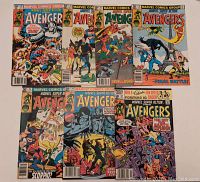 Photo showing the full lot of 8 Marvel Super Action Avengers comics including issues 28, 29, 31, 32, 33, 34, 37 fanned out on a surface.