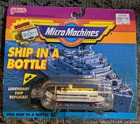 Front of original Galoob Micro Machines packaging showing Riverboat Dixie miniature ship inside bottle and promotional graphics