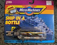 Front view of sealed blister pack Micro Machines 'Ship in a Bottle' with PT 448 World War 2 boat miniature inside plastic bottle container and colorful card backing.