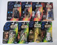 Eight Star Wars action figures in original card packaging laid flat, showing varying package conditions.