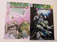 Two comic books featuring Teenage Mutant Ninja Turtles Ghostbusters 2 Issue 3 A and Variant B covers placed side by side on a flat surface.
