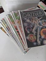 Partial fanned view of comics showing covers starting with issue number 1 with Dazzler title and various other issues in protective sleeves.