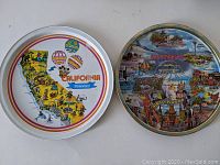 Photo showing two round serving trays side by side, one a colorful California Disneyland map with hot air balloons, the other a Los Angeles/Hollywood landmark collage tray.