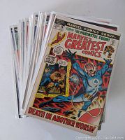 Stack of vintage Marvel's Greatest Comics featuring Fantastic Four, showing front cover of issue 38 with artwork depicting Mr. Fantastic in distress with The Thing and Human Torch in background.