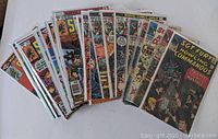 Photo of large fan spread of vintage Sgt Fury and His Howling Commandos comic books with various issue numbers.