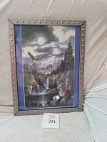 Frontal photo of the framed diamond painting showing the entire artwork including the moon, waterfall, and forest elements with the studded silver frame.