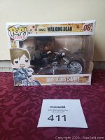 Funko Pop Rides boxed figure of Daryl Dixon on chopper motorcycle with minor box damage visible.