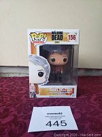 Front view of Funko Pop! Carol Peletier figure in original window box packaging, labeled #156 from The Walking Dead series.