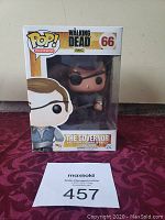Photo of The Walking Dead Funko Pop Governor figure #66 in original box on red textured surface