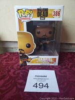 Funko Pop! The Walking Dead Gabriel figure number 386 in original box with clear window, showing figure holding a gun, box includes branding and series number.