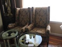 Pair of floral and velvet Temple Furniture wing chairs side by side.