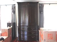 Full frontal view of Bernhardt entertainment armoire showing two-piece construction, five lower dovetailed drawers with brass-tone hardware, and double doors on upper cabinet section.
