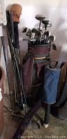 Two sets of left-handed golf clubs with bags, extra clubs and putting partner.