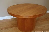 Full side view showing round top and cylindrical pedestal base