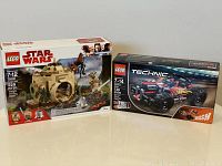 Side-by-side image showing sealed boxes of LEGO Star Wars Yoda's Hut set 75208 and LEGO Technic BASH! race car set 42073 on white surface.