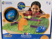Front of the boxed set showing the box art, product name, and child playing with the blue robot mouse and maze setup.