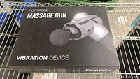 Closed box labeled 'Portable Massage Gun Vibration Device' with image of the gun on the front.
