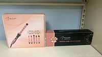Box packaging of Bestope 5-in-1 curling wand and digital hair straightener side by side.