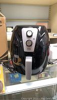 Photo of black Utopia Kitchen Model UK0382 air fryer showing front panel with two control dials and pull handle.