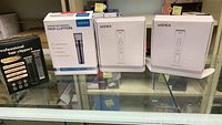 Three boxes of Woner hair clippers and a professional hair clipper box on glass table