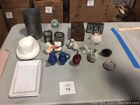 Full view of all table top items including trays, bowls, salt and pepper shakers, figurines, glass paperweights, candle holders, and a small wooden box.