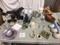 Full lot on table showing Japanese sake set, wooden bowls, ceramic vases, assorted glassware, small decorative items and plates, battery candle.