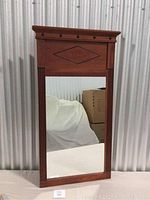 Front view of the Ethan Allen cherry stained decorative mirror showing rectangular shape, diamond inlay detail, fluted side columns, and black decorative round accents on top edge.