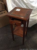 Front and side view of tall pedestal table showing drawer and lower shelf