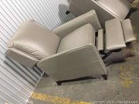 One chair fully reclined showing footrest extended and side profile