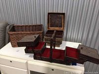 Overview photo showing the wicker baskets and the antique wooden craft box with compartments open and red fabric visible.