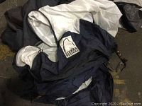 Close-up of folded Sierra Designs small tent with label visible