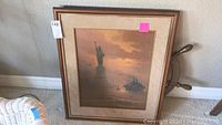 Framed G. Harvey print showing Statue of Liberty with a ship at sunset in warm tones
