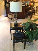 Photo showing the two stacking tables with the lamp on the larger one and elephant figurine on the smaller. Artificial plant visible beside tables.