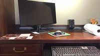 Dell monitor, keyboard, mouse, Sony speaker on desk