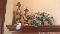 Wooden finials and artificial greenery on a mantle