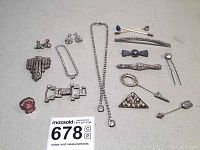 Full overhead photo with all vintage rhinestone costume jewelry pieces alongside a ruler for scale.