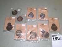 Nine limited edition Estabrook Trail Walk medals in original packaging, two sterling and seven bronze, with numbered cards visible