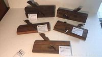 Group photo of all five antique wood block planes showing their sizes and relative condition.