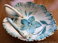 Top angle of the hand-painted swan dish showing floral design and scalloped edges with gold accents
