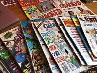 Collection of 16 vintage Cracked magazines fanned out showing varied colorful illustrated and photographic covers including Michael Jackson theme, rock & roll calendar and comic art.